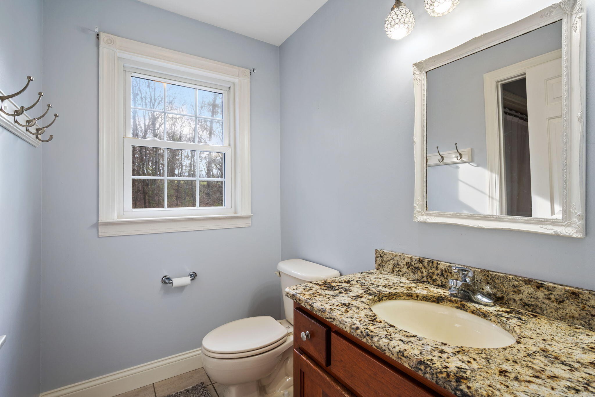 153 Nix Road Dunlap, TN 37327 - Photo 29 of 61 a bathroom with a granite countertop sink a mirror and a toilet