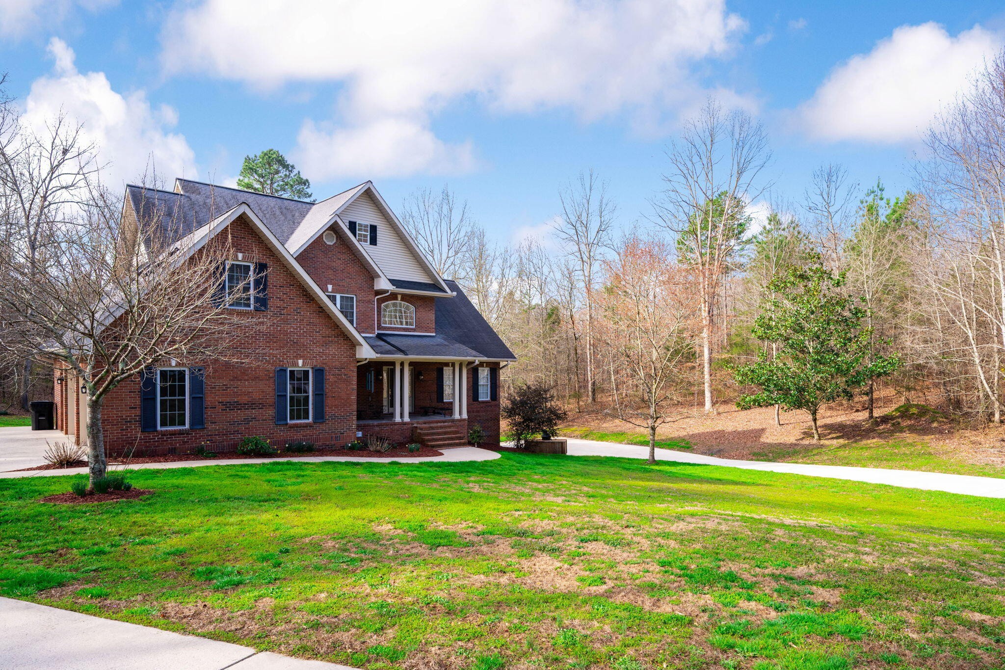153 Nix Road Dunlap, TN 37327 - Photo 6 of 61 a front view of a house with a garden and trees