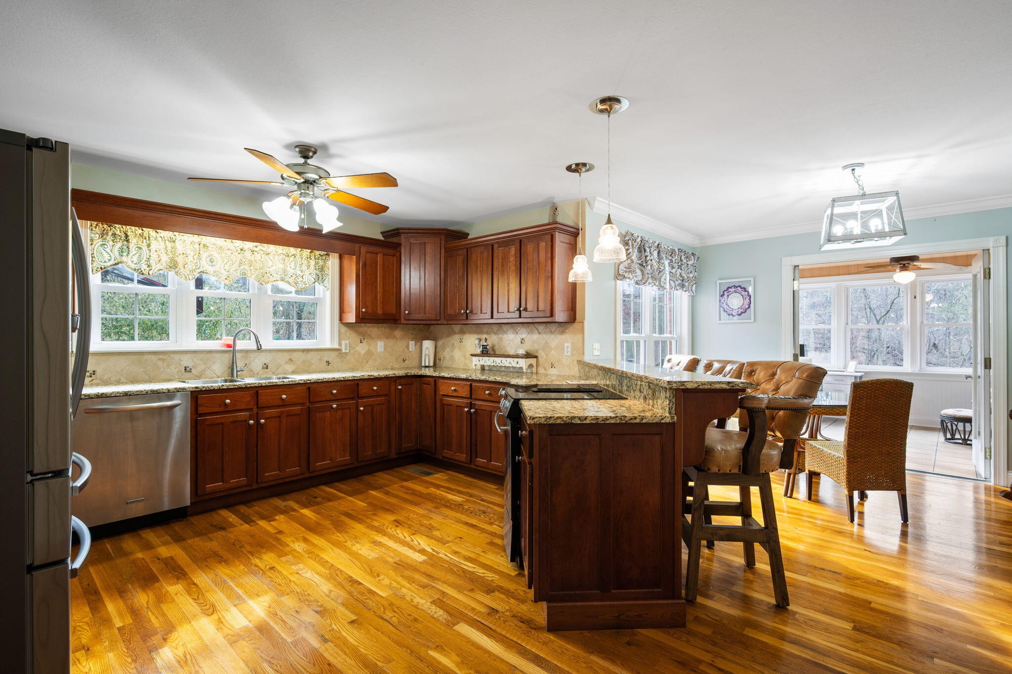 153 Nix Road Dunlap, TN 37327 - Photo 9 of 61 a kitchen with stainless steel appliances granite countertop a stove a refrigerator a sink a dining table and chairs with wooden floor