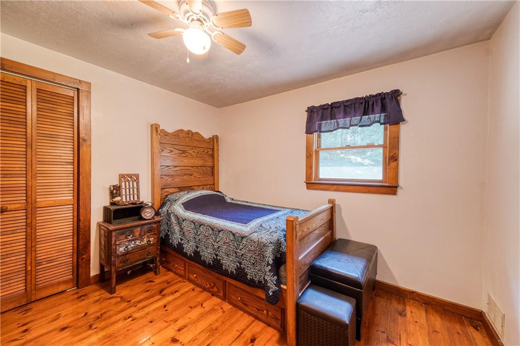 321 Westminster Road Sarver, PA 16055 - Photo 19 of 25 a bedroom with a bed and wooden floor