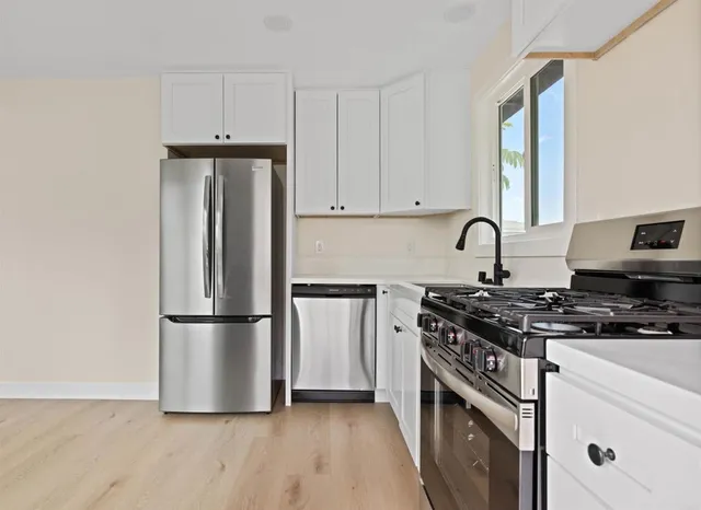 a kitchen with a refrigerator stove and sink