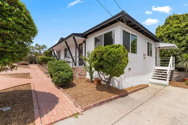 a front view of a house with garden