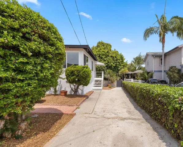 a view of a backyard with potted plants
