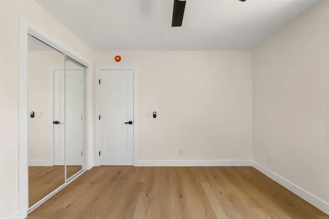 a view of a room with wooden floor