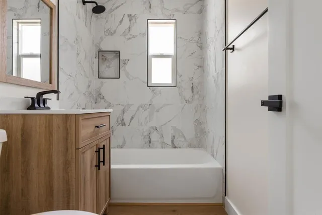 a bathroom with a bathtub and a sink