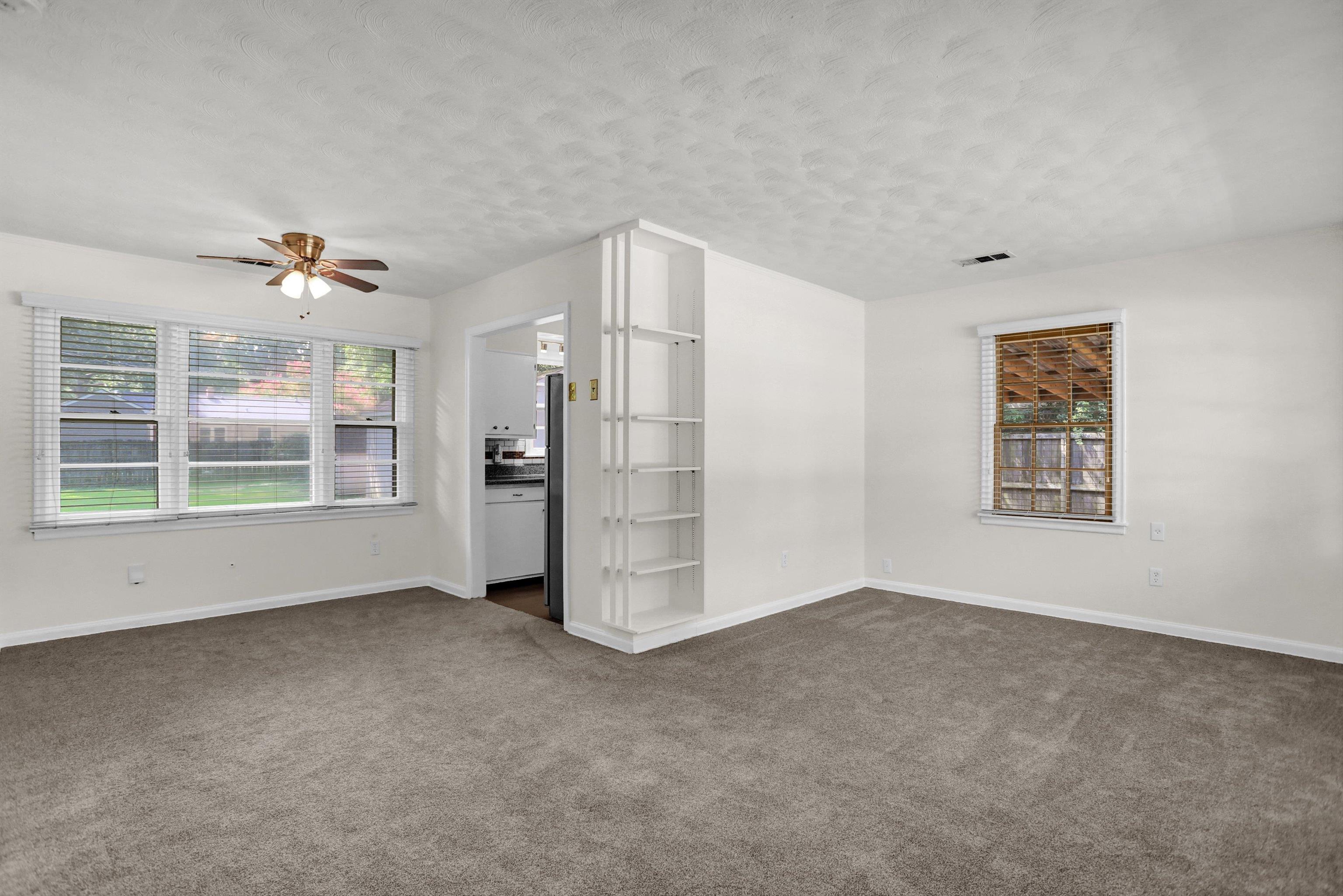 4545 Flamingo Road Memphis, TN 38117 - Photo 7 of 34 Spacious room with gray carpeting and white painted walls
