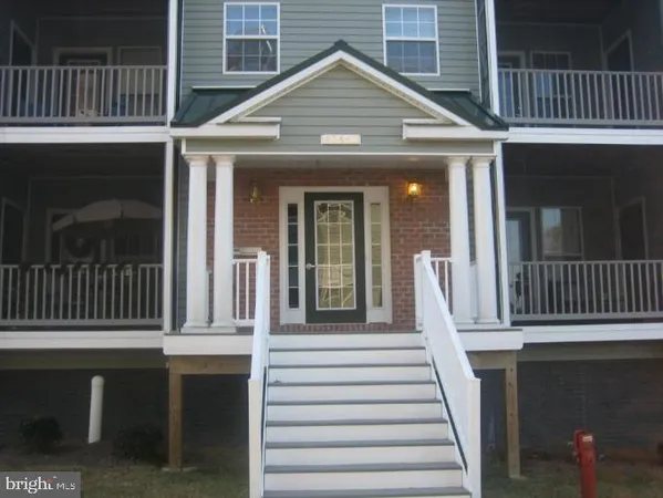 a view of a house with wooden porch