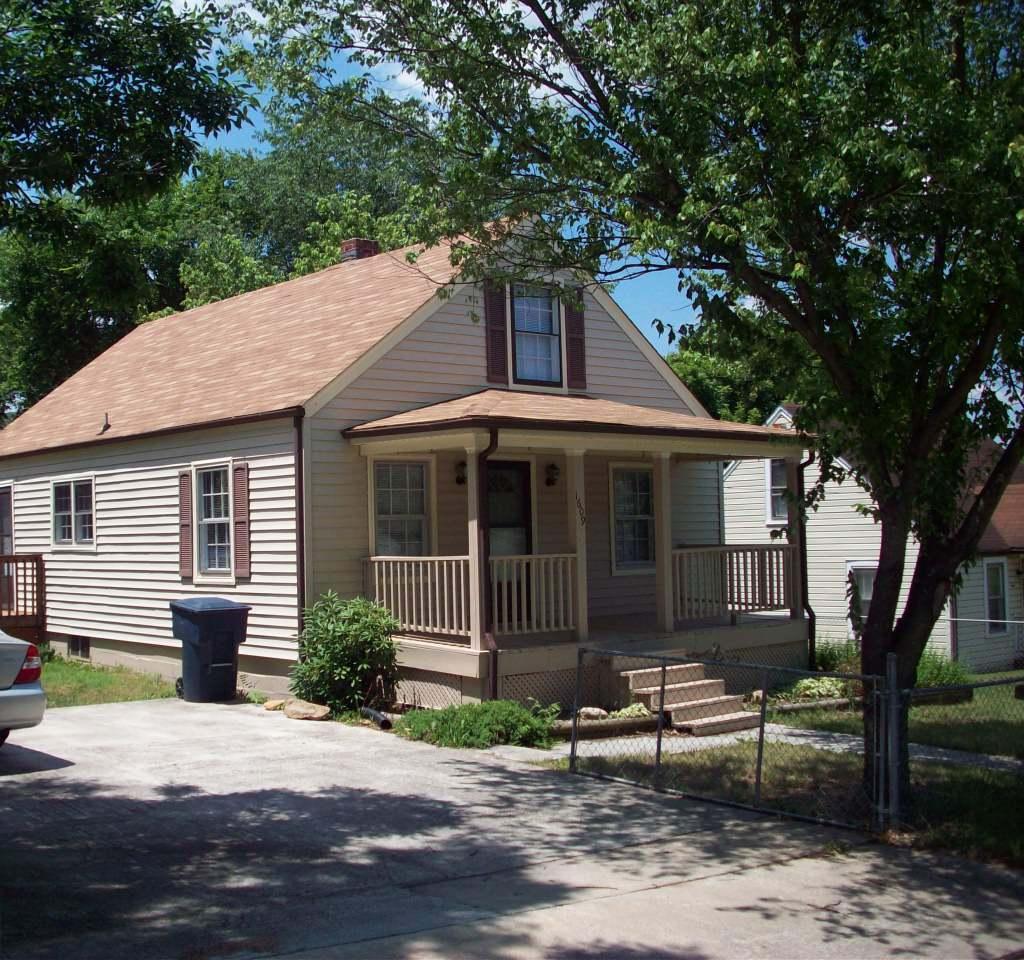 1609 Riverside Terrace Southeast Roanoke, VA 24014 - Photo 1 of 6 a front view of a house with a garden
