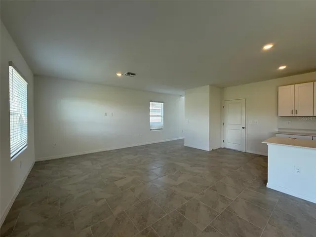 a view of an empty room and a window