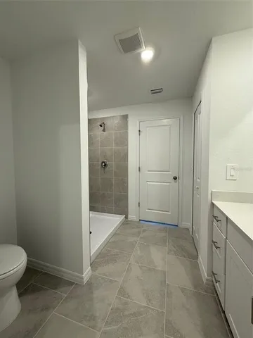 a bathroom with a shower and a toilet