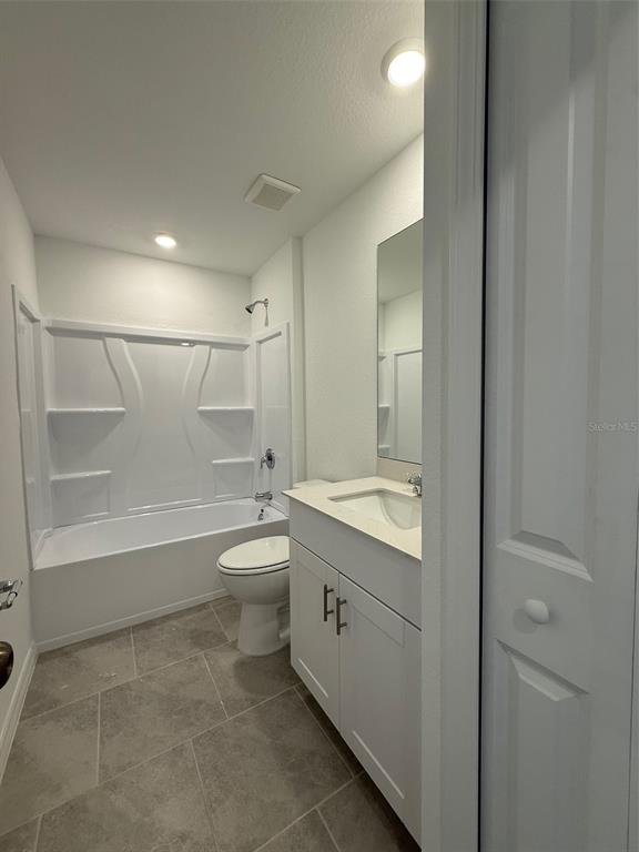 11795 Cloverly Lane Punta Gorda, FL 33955 - Photo 27 of 36 a bathroom with a granite countertop sink a toilet and shower