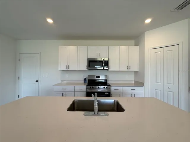 a kitchen with a cabinets and a stove top oven