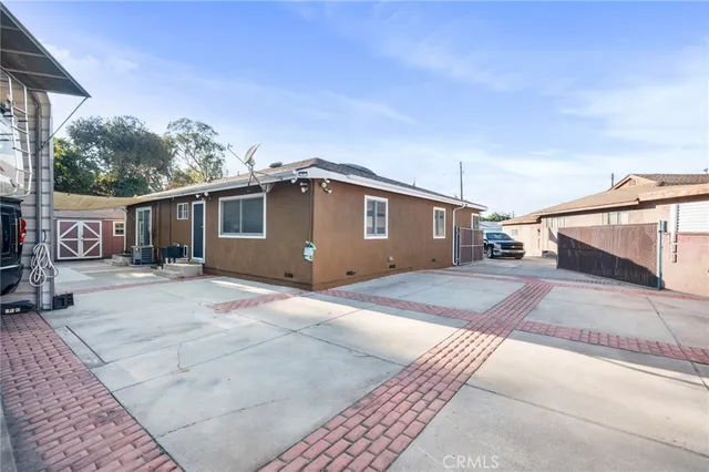 a view of a house with a wooden fence