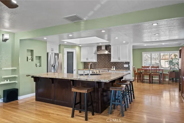 a kitchen with a sink cabinets and wooden floor