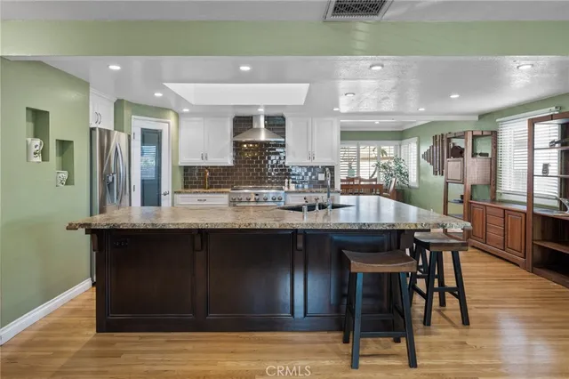 a kitchen with a sink and a stove top oven