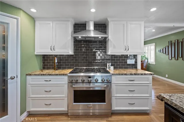 a kitchen with kitchen island a counter space a sink stainless steel appliances and cabinets