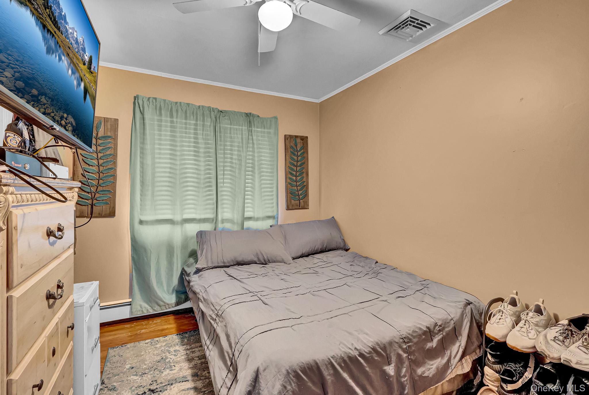 98 Granny Road Farmingville, NY 11738 - Photo 16 of 24 a bedroom with a bed and a chandelier