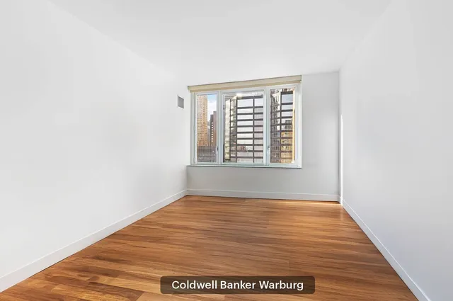 a bedroom with a bed and a window in it