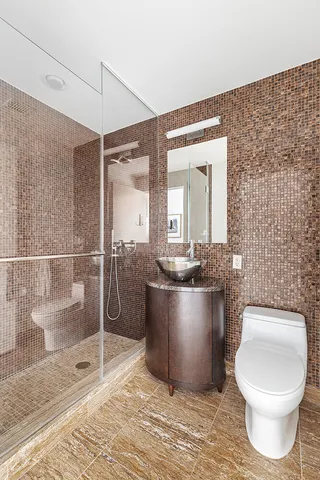 a bathroom with a granite countertop sink a toilet and bathtub