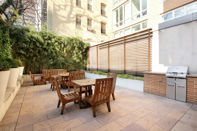 a bedroom with furniture and a large window