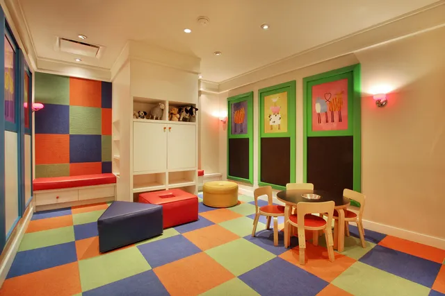 a dining room with a wooden table and chairs