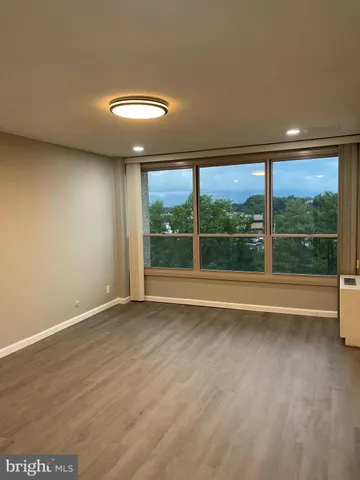 a view of an empty room with a large window