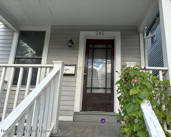 a view of balcony with wooden floor and flowers