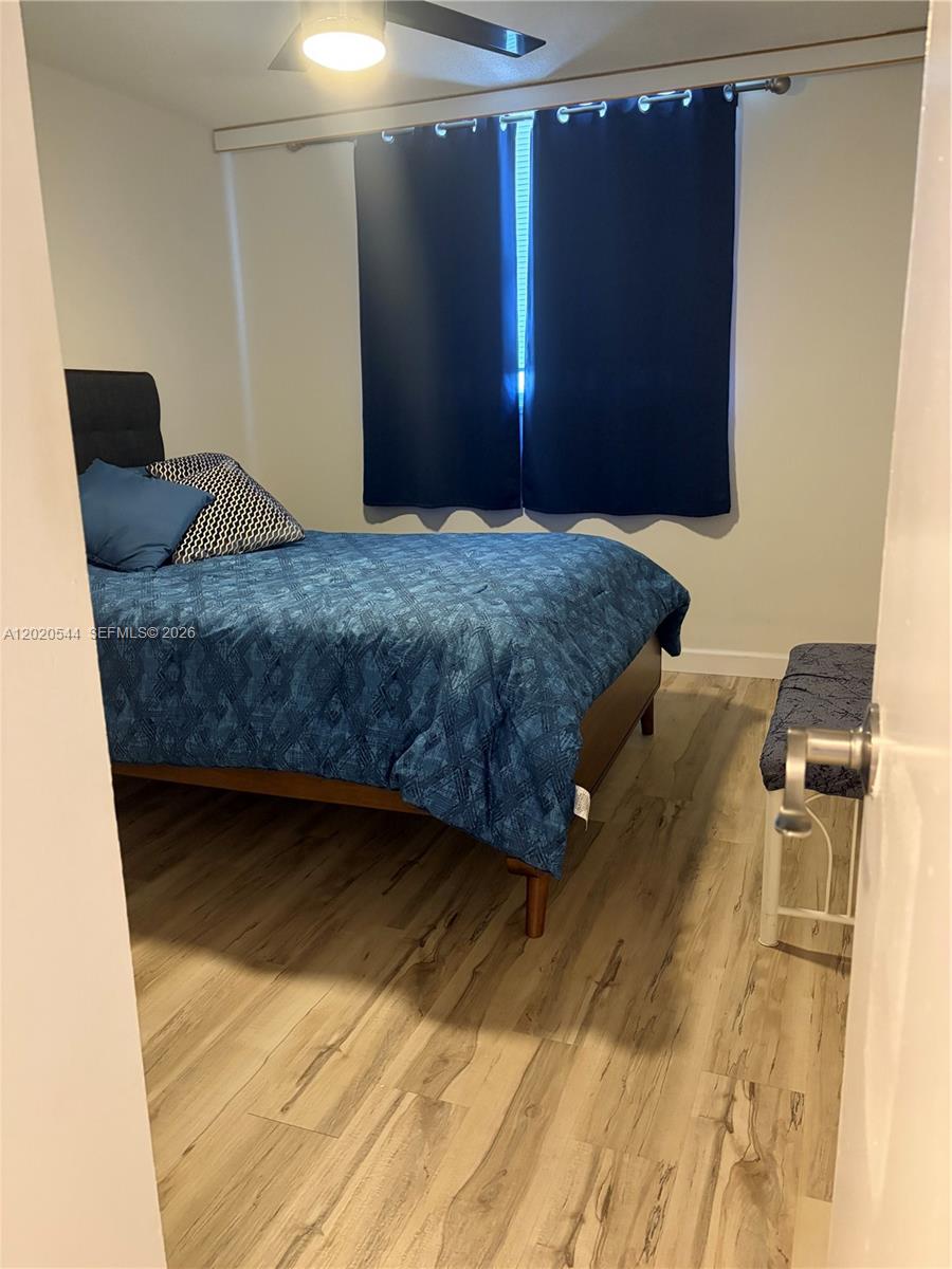 1913 South Ocean Drive, Unit 427 Hallandale Beach, FL 33009 - Photo 16 of 16 a bedroom with a bed and wooden floor