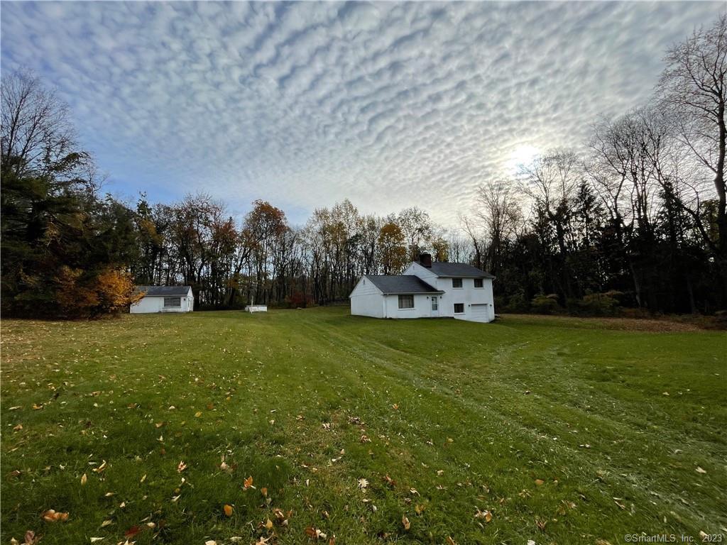 14 State Line Road New Fairfield, CT 06812 - Photo 1 of 1 a front view of a house with garden