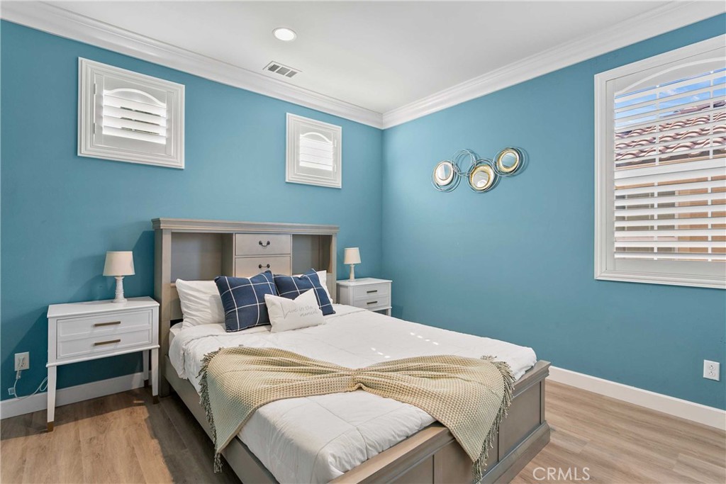 13078 Irisbend Avenue Eastvale, CA 92880 - Photo 11 of 23 a bedroom with a bed and a window