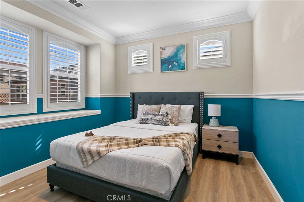 13078 Irisbend Avenue Eastvale, CA 92880 - Photo 12 of 23 a bedroom with a bed and a window