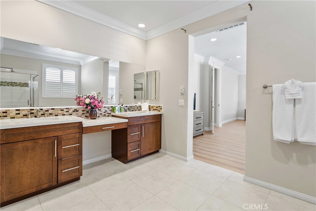 13078 Irisbend Avenue Eastvale, CA 92880 - Photo 17 of 23 a spacious bathroom with a sink mirror and a shower