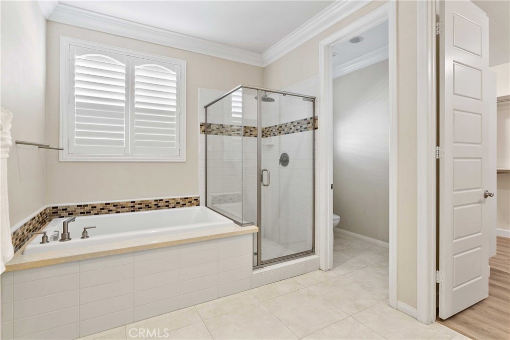 13078 Irisbend Avenue Eastvale, CA 92880 - Photo 20 of 23 a bathroom with a tub and a window