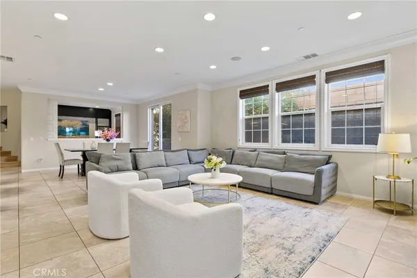 a living room with fireplace furniture and floor to ceiling windows