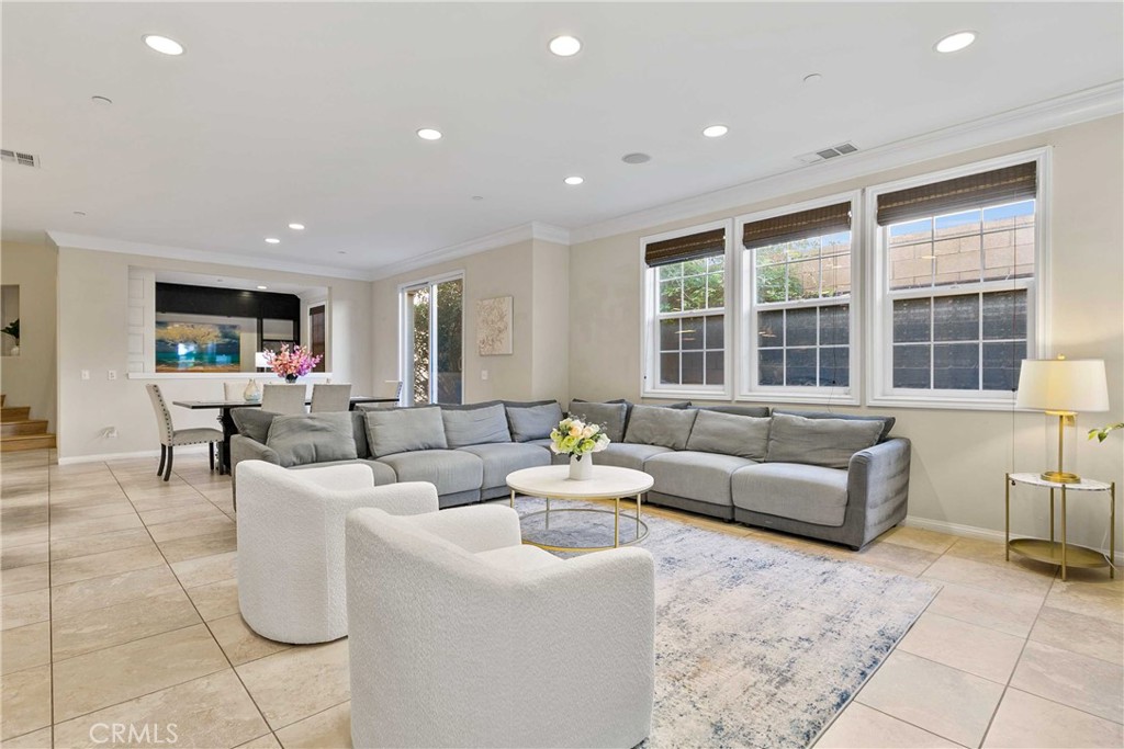 13078 Irisbend Avenue Eastvale, CA 92880 - Photo 2 of 23 a living room with fireplace furniture and floor to ceiling windows