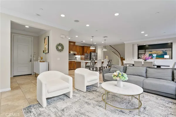 a living room with furniture and a view of kitchen