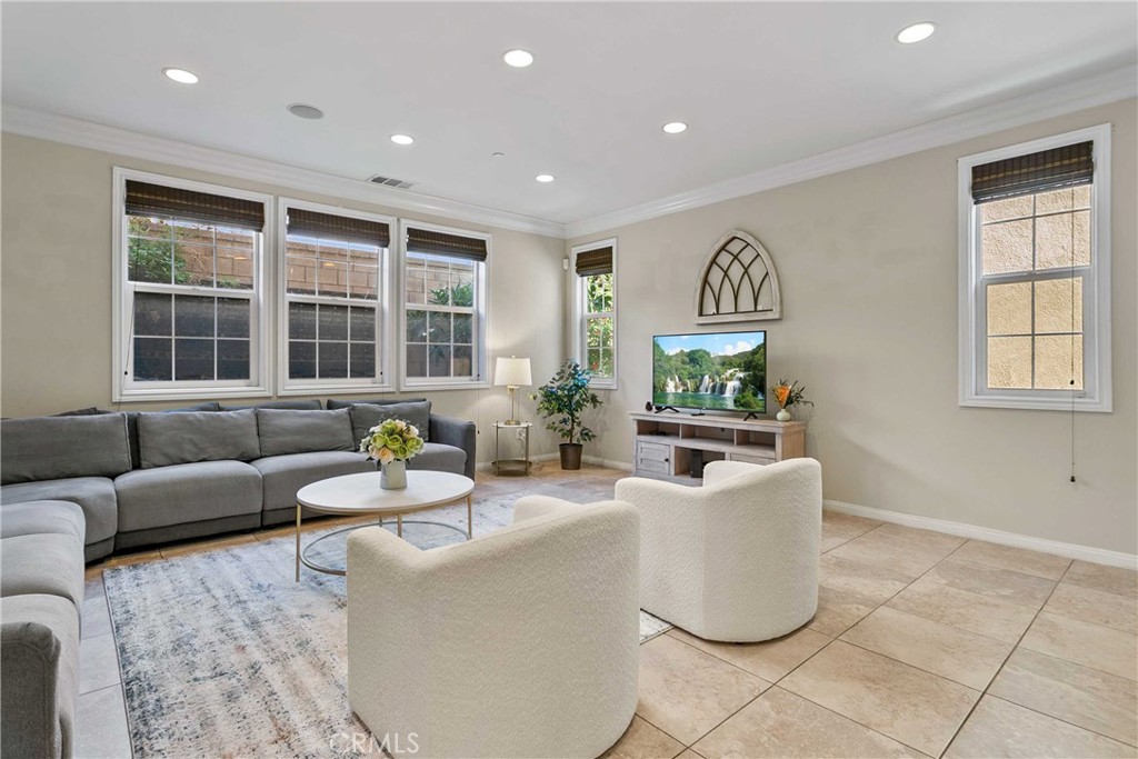 13078 Irisbend Avenue Eastvale, CA 92880 - Photo 4 of 23 a living room with furniture and a flat screen tv