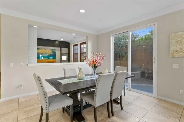 a view of a dining room with furniture and a potted plant