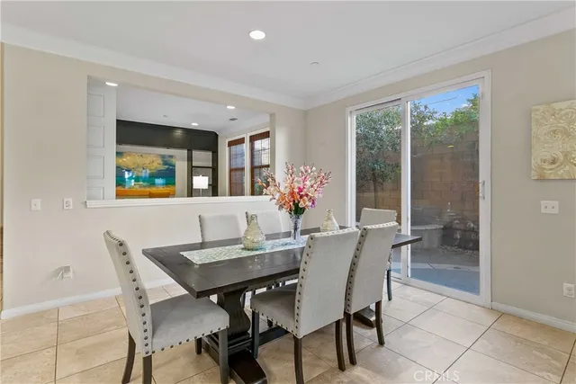 a view of a dining room with furniture and a potted plant