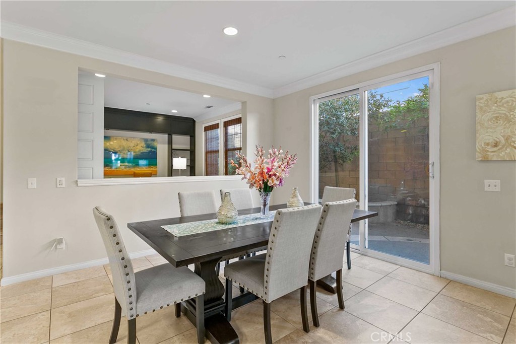 13078 Irisbend Avenue Eastvale, CA 92880 - Photo 5 of 23 a view of a dining room with furniture and a potted plant