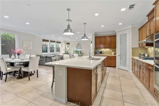 a kitchen with stainless steel appliances kitchen island granite countertop a sink and cabinets