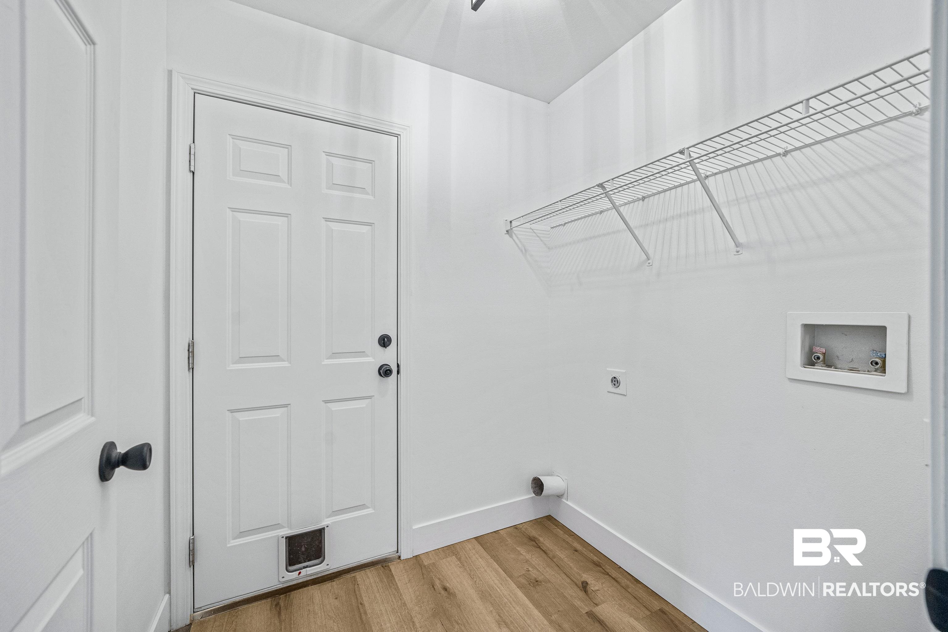9243 Brookshire Loop Daphne, AL 36526 - Photo 15 of 26 Laundry room with hookup for a washing machine, electric dryer hookup, and light hardwood / wood-style flooring