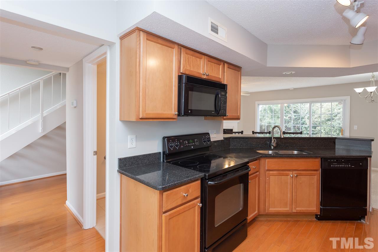 7812 Falcon Rest Circle Raleigh, NC 27615 - Photo 13 of 26 a kitchen that has a sink and a stove top oven