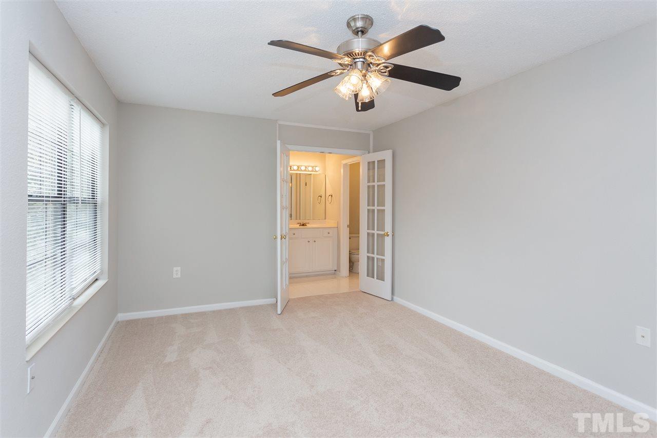7812 Falcon Rest Circle Raleigh, NC 27615 - Photo 17 of 26 an empty room with windows and fan