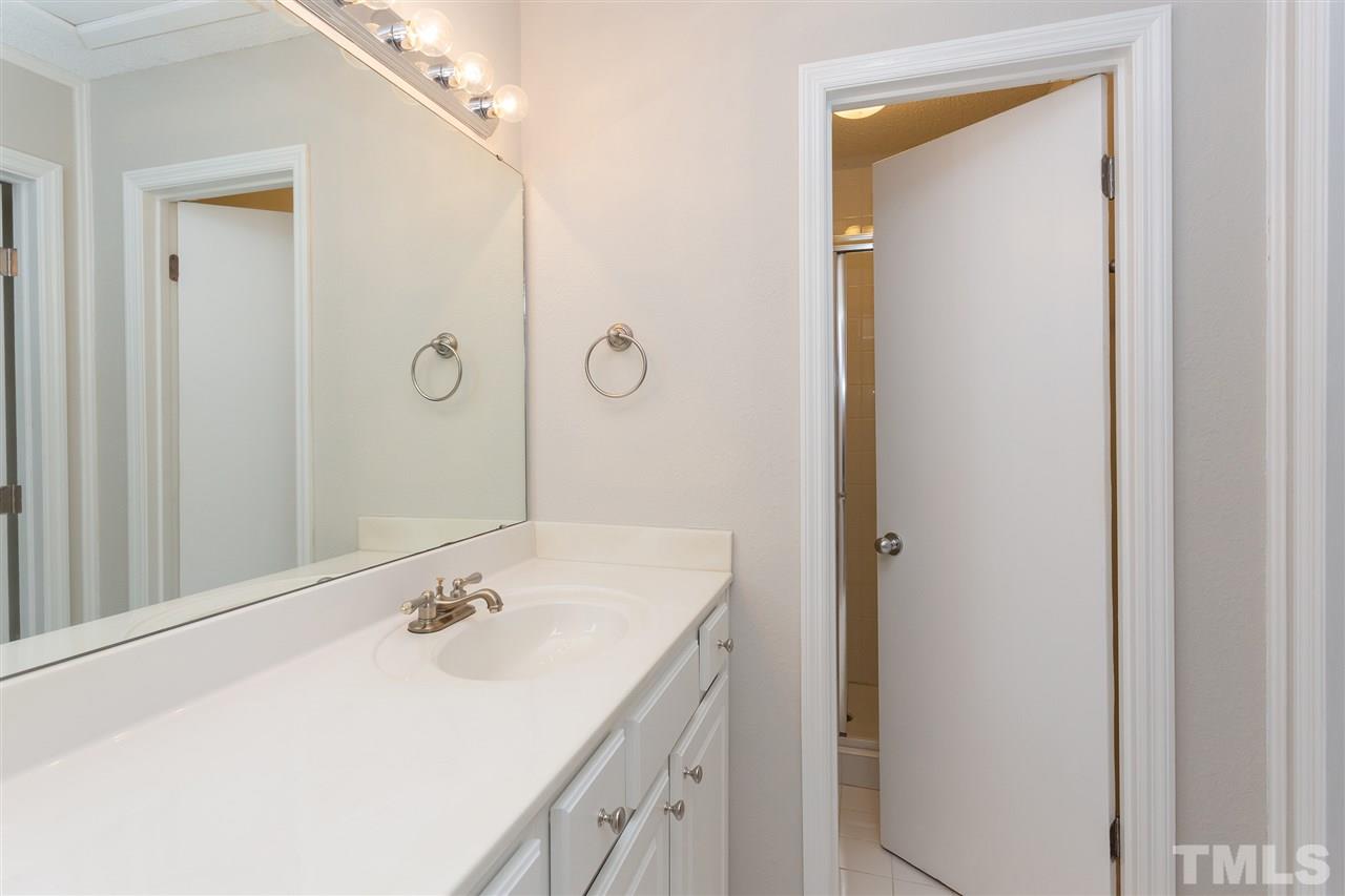 7812 Falcon Rest Circle Raleigh, NC 27615 - Photo 19 of 26 a bathroom with a sink vanity granite tub and shower