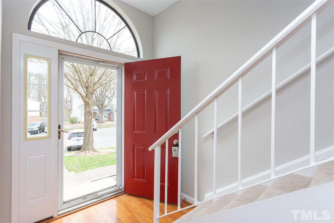 7812 Falcon Rest Circle Raleigh, NC 27615 - Photo 3 of 26 a view of an entryway with wooden floor and door