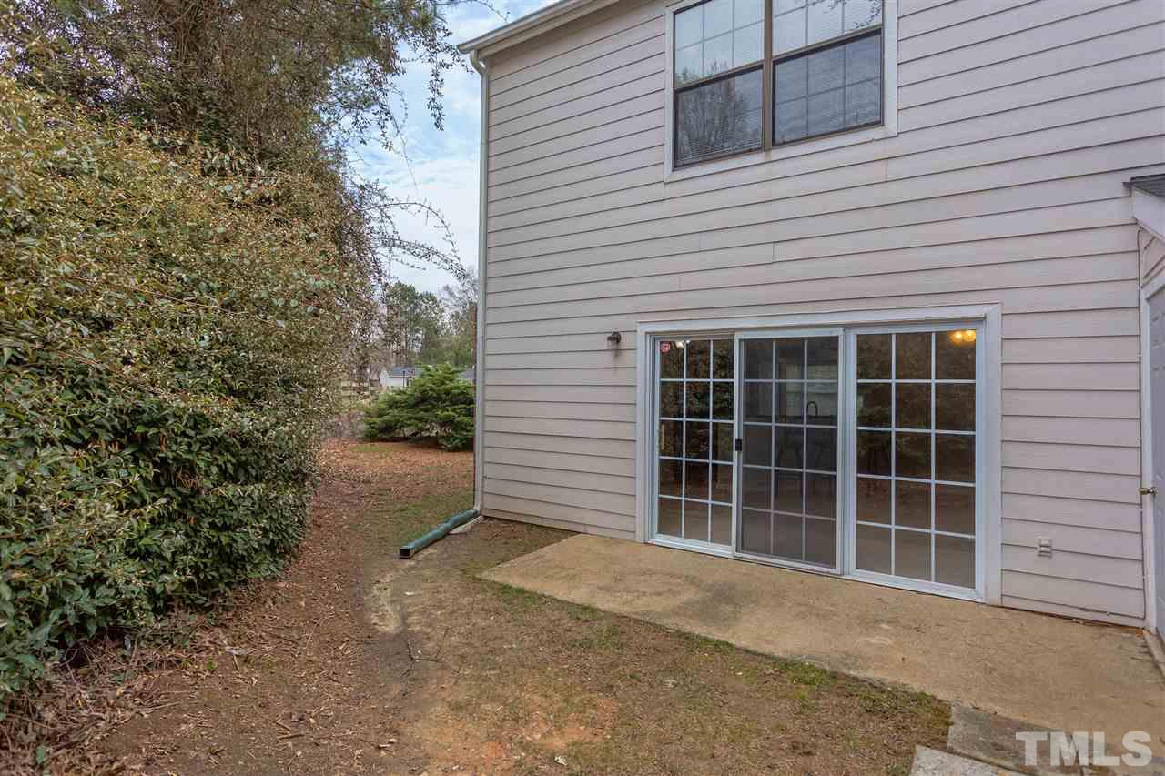 7812 Falcon Rest Circle Raleigh, NC 27615 - Photo 25 of 26 a front view of a house with a yard and garage