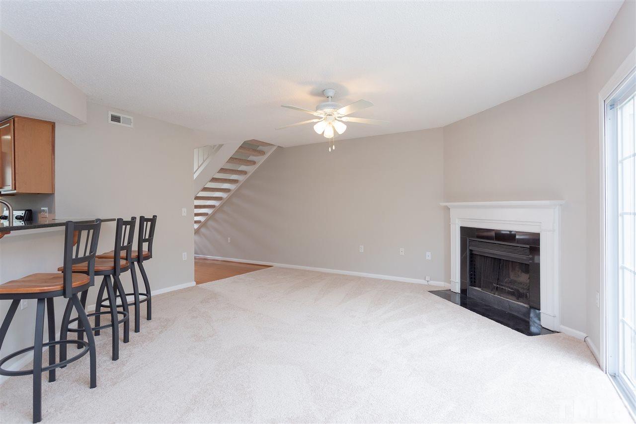 7812 Falcon Rest Circle Raleigh, NC 27615 - Photo 6 of 26 a view of a livingroom with a fireplace and a chandelier
