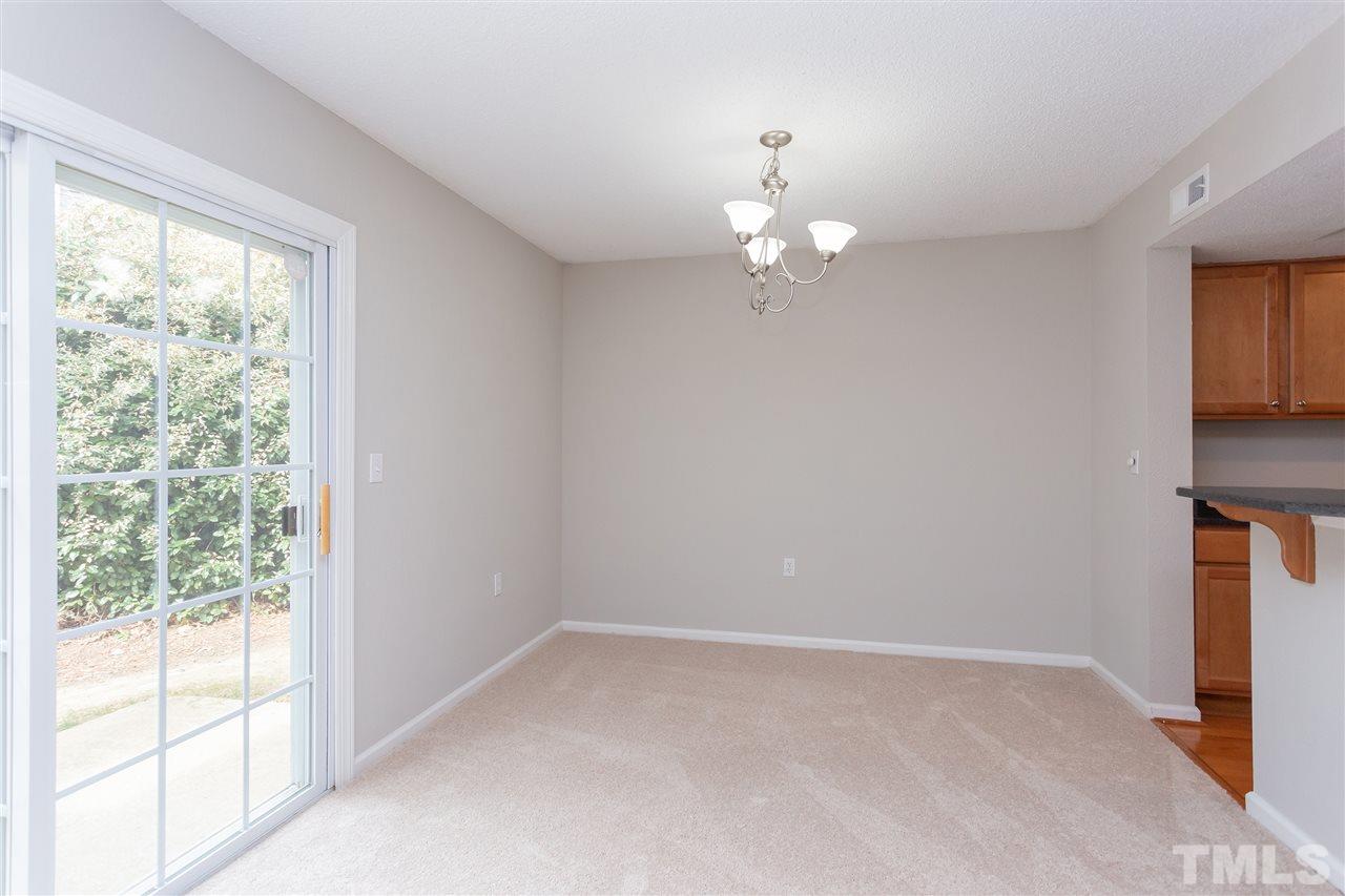 7812 Falcon Rest Circle Raleigh, NC 27615 - Photo 9 of 26 a view of empty room with wooden floor and fan