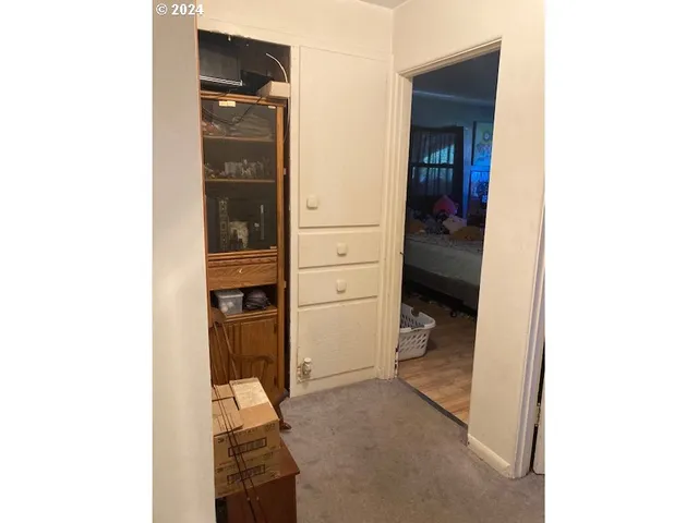 a view of walk in closet with living room